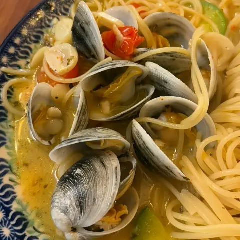 Clam pasta served with zucchini and cherry tomatoes