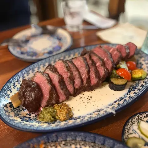 Sliced steak served with grilled vegetables