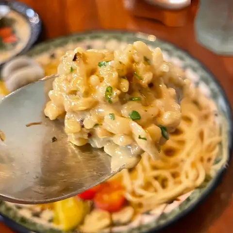 Creamy spoonful of risotto with herbs and grains
