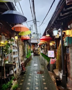Colorful umbrellas decorate a narrow alley in ikseondong hanok village