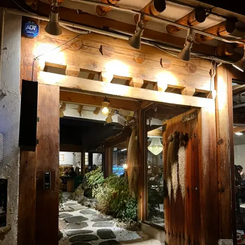 Hanok-style restaurant entrance at night with garden lights