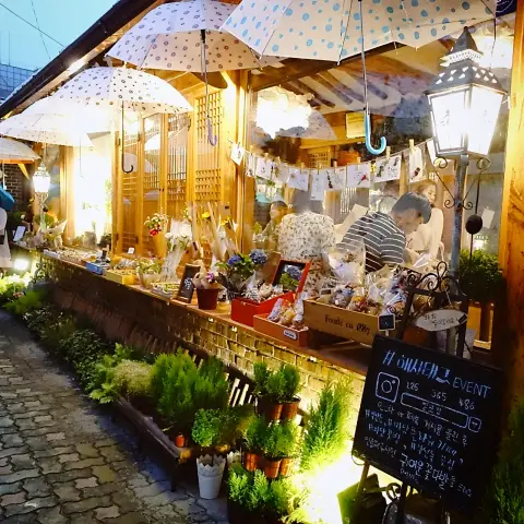 Umbrella-lit hanok shop with local goods on display