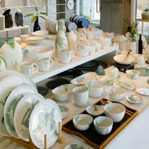 White and green handmade Korean ceramicware on display