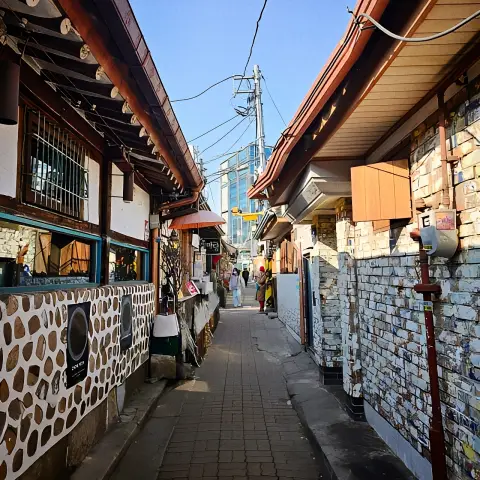 Daytime alley view in Ikseon-dong with tiled hanok walls