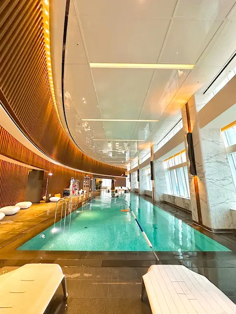 bright indoor swimming pool with city view