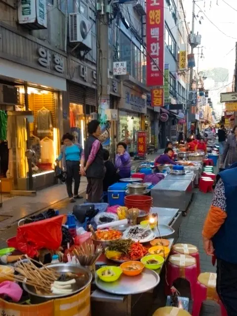 Street food stalls and local vendors in a traditional Busan market