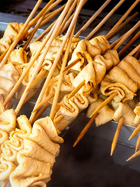 Steaming fish cake skewers (eomuk) from a street food stall in Busan
