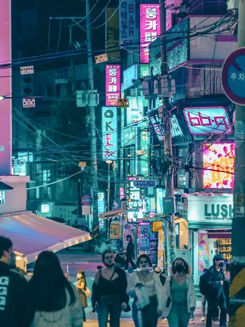 Night view of crowded street filled with neon signs and bars