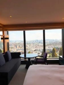Modern hotel room with a king-size bed and panoramic windows