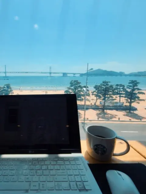 Remote working at a café with a view of Gwangalli Beach and Gwangan Bridge

