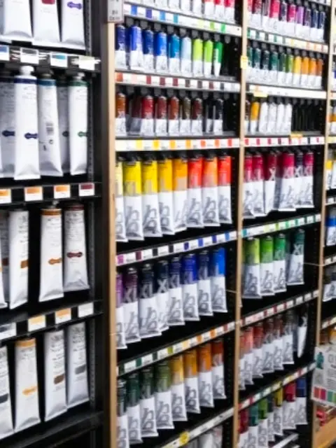 Rows of colorful paint tubes arranged on shelves