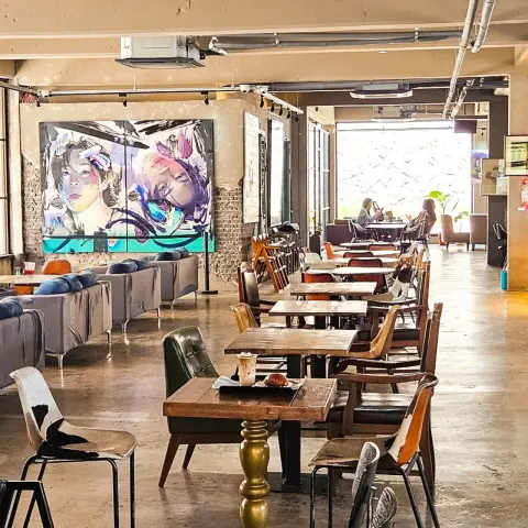 ZM illennial spacious interior with mural, mixed seating, and warm light