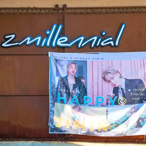 ZM illennial exterior sign with a Happy Jimin Day birthday banner