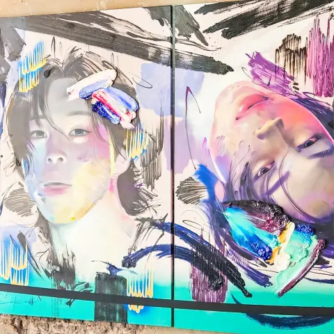 Close‑up of a colorful mixed‑media portrait diptych on a concrete wall