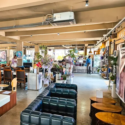 ZM illennial spacious interior with leather sofas, flowers, and a pastry counter