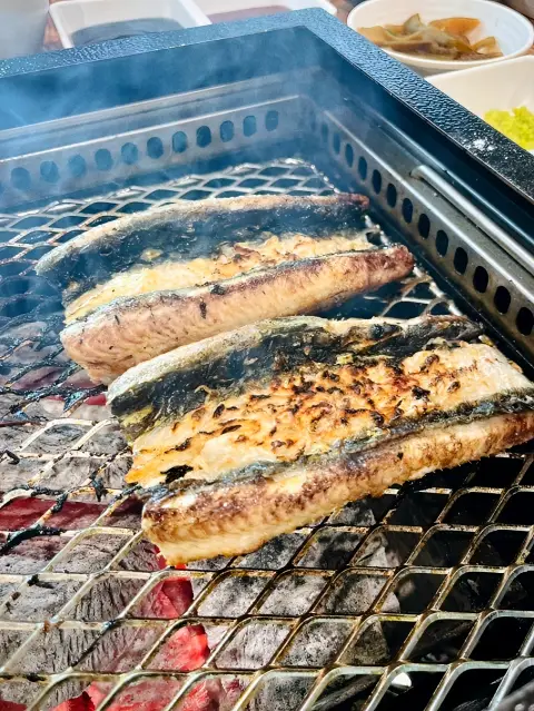 Grilled eel sizzling over charcoal at Ilpyeon Jangeo Hongdae