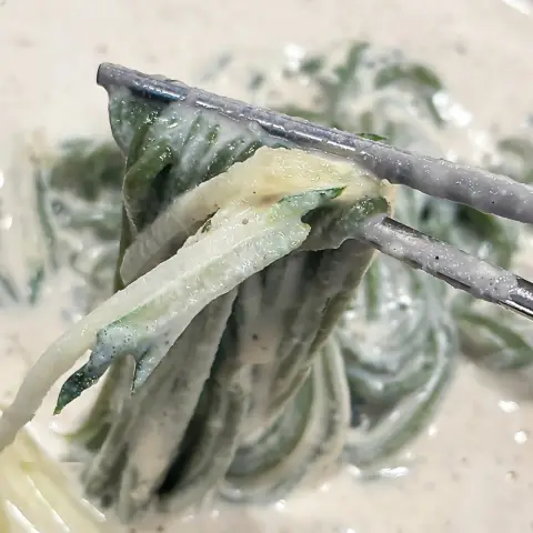 Close-up of kongguksu noodles with cucumber and creamy soybean broth