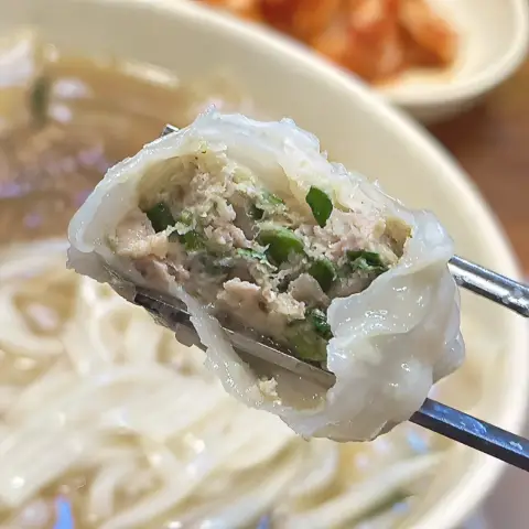 Myeongdong Kyoja mandu cross-section showing juicy pork and chive filling