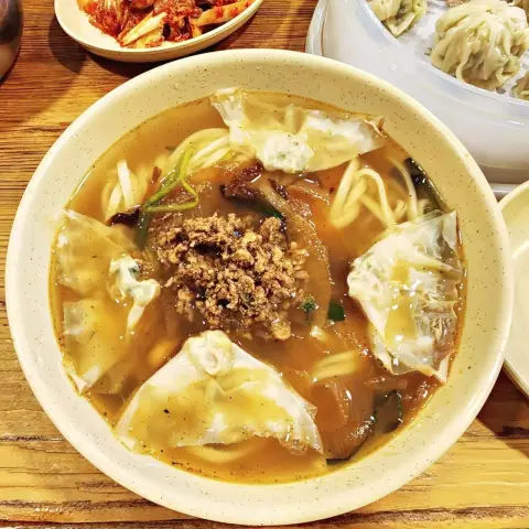 Myeongdong Kyoja kalguksu served with dumplings and minced meat topping