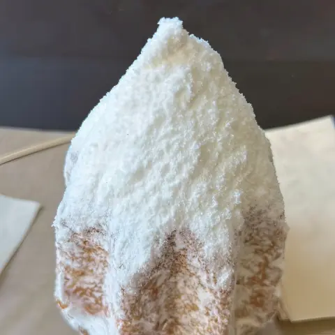 Close-up of soft Pandoro pastry topped with powdered sugar