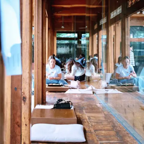 Low wooden floor seating with cushions inside the hanok interior