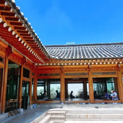 Hanok courtyard with open seating area and visible tiled roofline