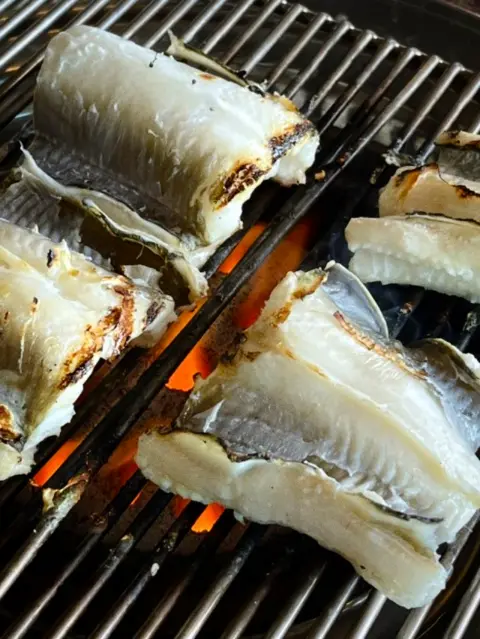 Grilled eel sizzling on the charcoal at a Cheongsapo restaurant