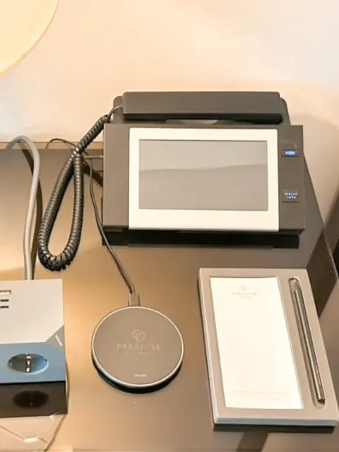 in-room phone with tablet and branded stationery