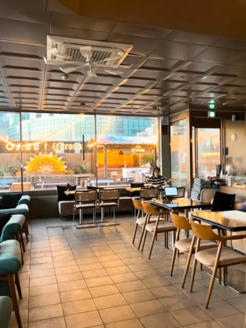 Indoor seating area with large windows at Oase