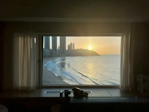 westin-josun-busan-room-sunset-view.webp Sunset over Haeundae Beach seen from Westin Josun Busan room