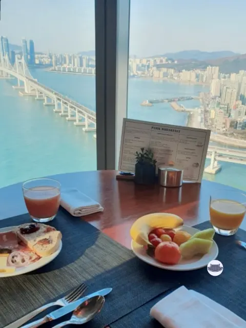Park Hyatt Busan breakfast table with fruit, pastries, and ocean view
