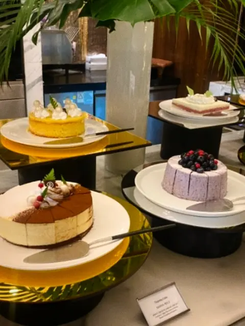 dessert section with assorted cakes at hotel buffet