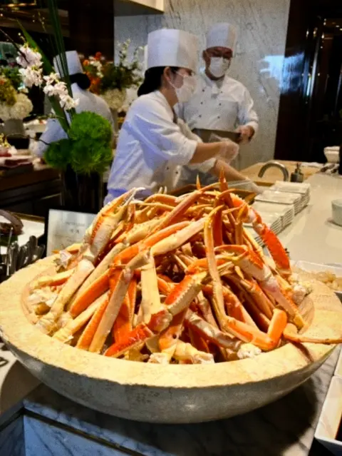 snow crab tower at seafood buffet counter
