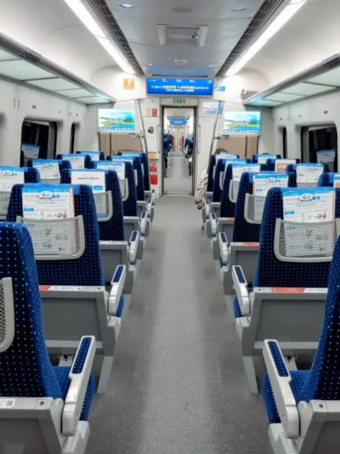 AREX Express Train interior seats with reserved seating and luggage racks
