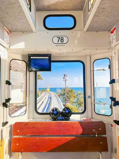 Interior view from capsule 78 at Haeundae Blueline Park, overlooking the sea