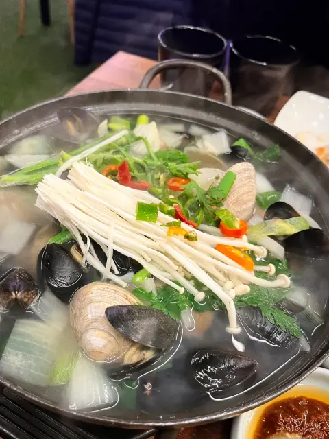 Cheese-topped shellfish butter tray on the grill