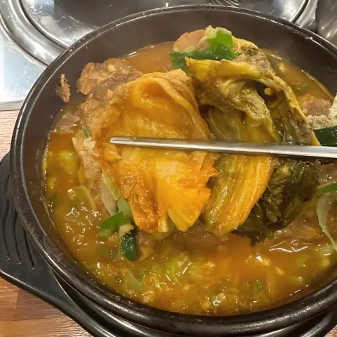 Kimchi-topped pork bone soup at Boseong Hoegwan Hongdae