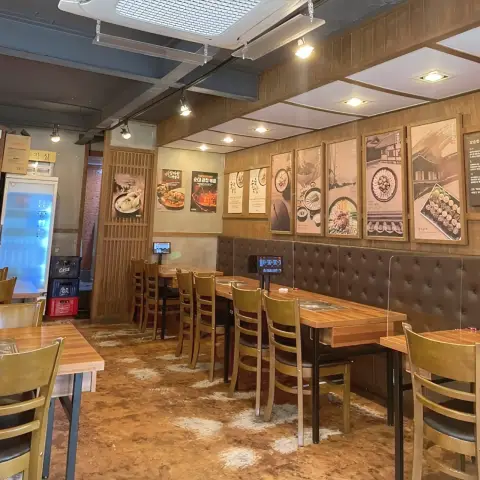 Interior of Boseong Hoegwan Hongdae with wooden decor and food posters