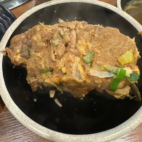 Pork bone chunk served in gamjatang-style dish at Boseong Hoegwan