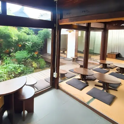 tatami mat seating area with garden view through glass wall