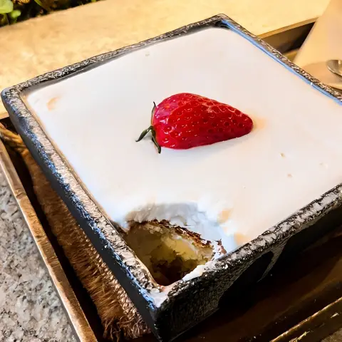 close-up of strawberry castella with soft cream and a missing bite