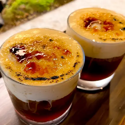 close-up of two torched cream egg coffees with caramelized tops