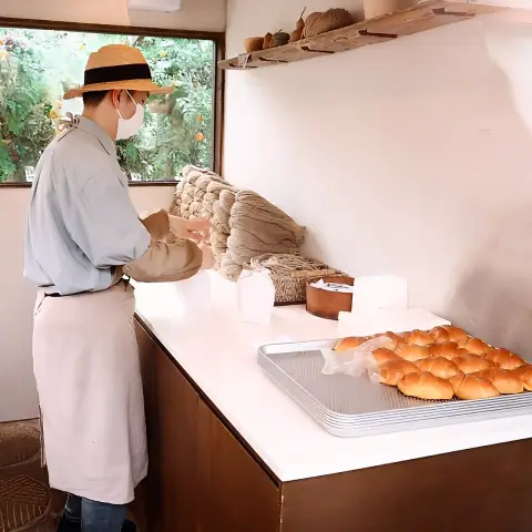 Staff preparing Jayeondo Salt Bread behind the counter at Ikseon-dong