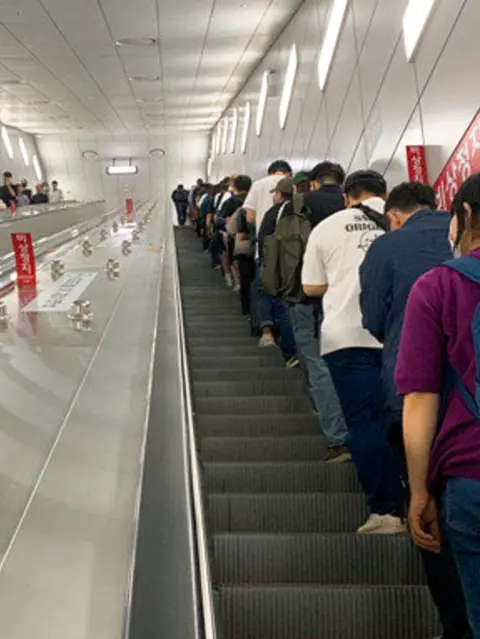 Passengers lined up on the escalator at Seoul subway station