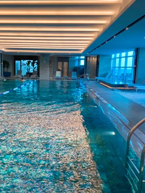 Indoor swimming pool at Signiel Busan with ocean-facing windows
