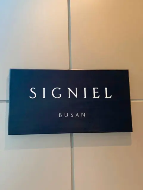 signiel-busan-interior-logo-sign.webp Signiel Busan logo sign inside the hotel