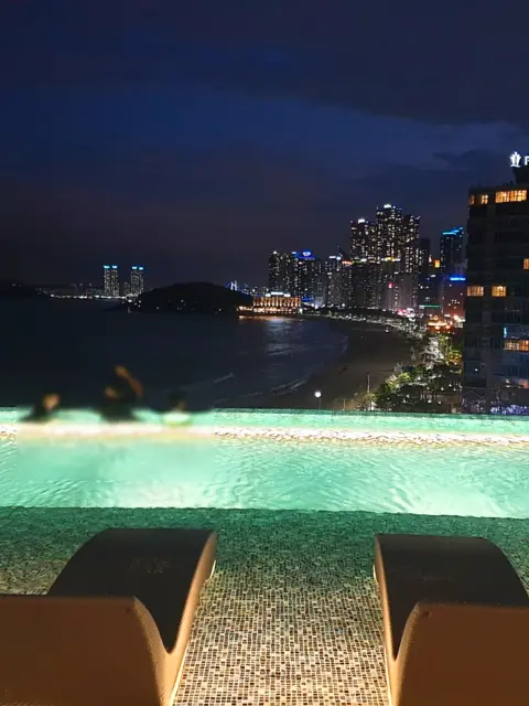 Night view of Signiel Busan’s infinity pool overlooking Haeundae Beach