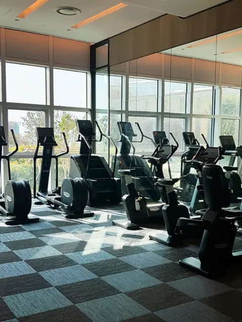 Fitness center cardio machines at Signiel Busan with window views