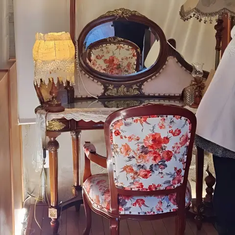 Floral vintage chair and vanity set in a softly lit space