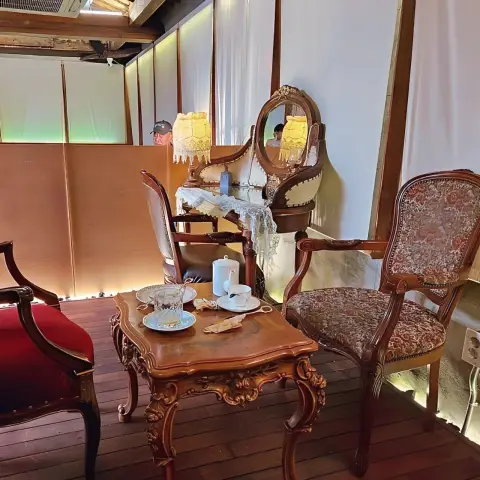 DongBaek Bakery’s antique seating with teacups and soft lamp lighting